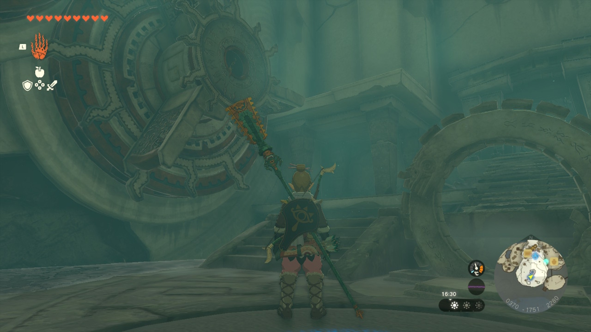 Link standing by gears in Tears of the Kingdom.